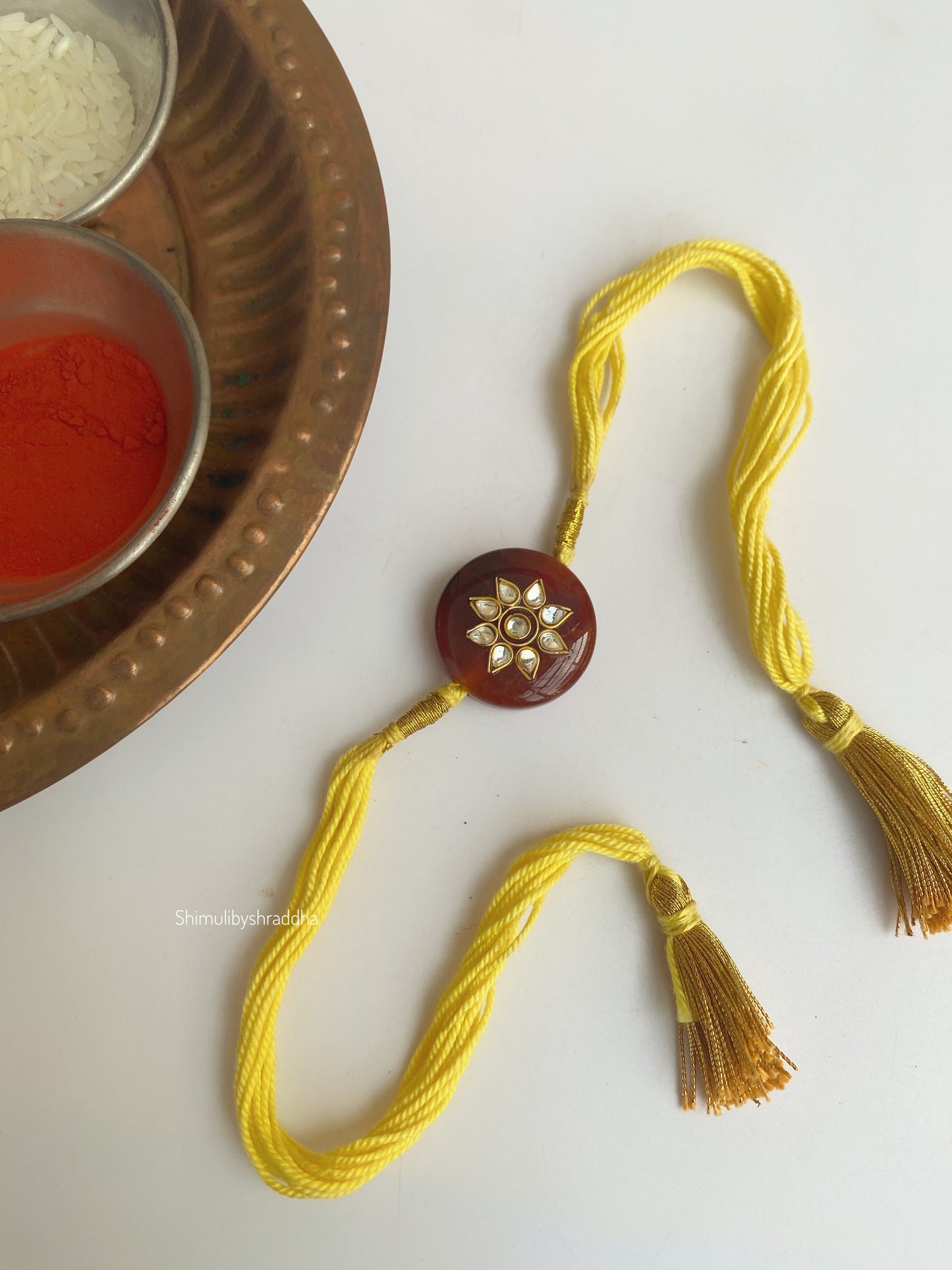 Natural stone rakhi with kundan work